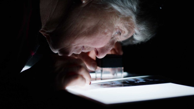 Fiona looks at an image on a lightbox