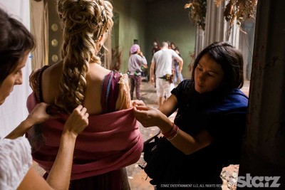 Costume standby Anna Voon makes adjustments